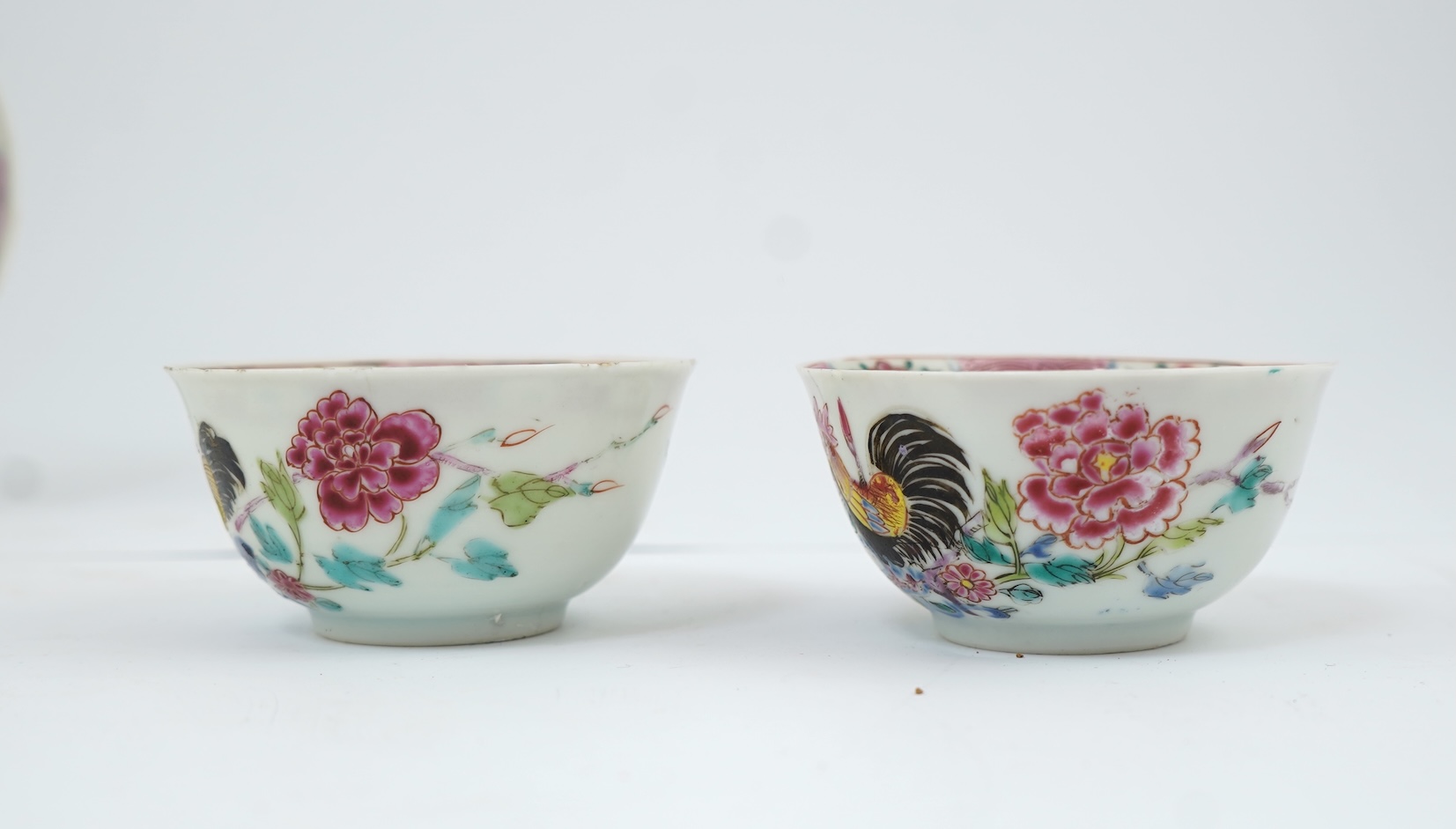 A near pair of Chinese famille rose ‘cockerel’ tea bowls and saucers, Yongzheng period
